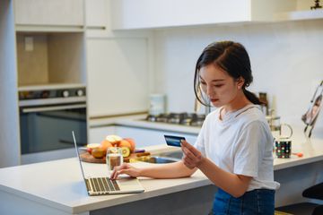 Woman shopping online with credit card.