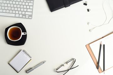 White office desk with a lot of things on it