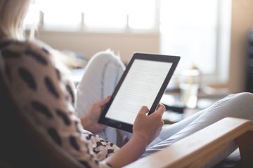 Woman reading free book on digital reader