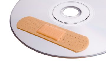 CD with bandaid, indicating that it's been scratched due to unsafe cleaning