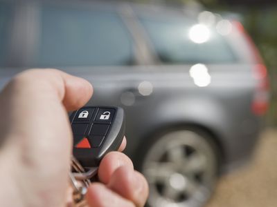 Key fob pointed at a SUV in the background