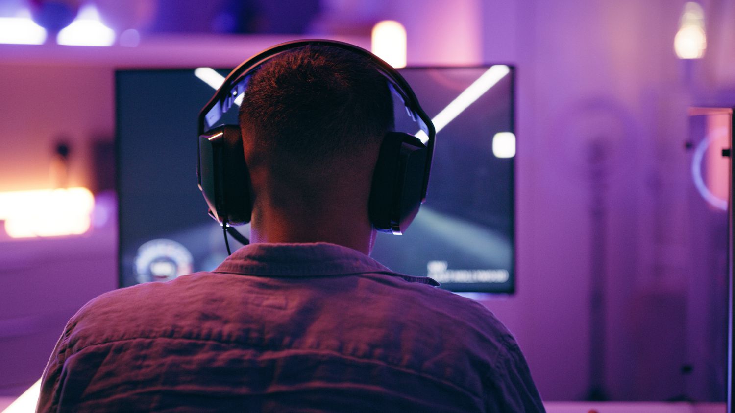 A person gaming with headphones