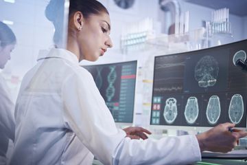 Neuroscientists examining brain scans in a lab.