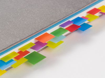 Multi Colored Adhesive Notes in Books on White Background