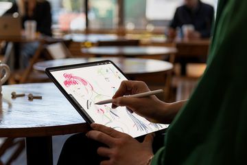 A man sketching on an iPad Pro using an Apple Pencil