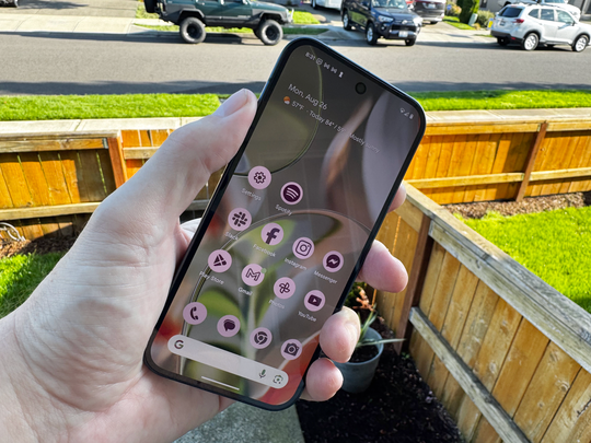 Google Pixel 9 in a hand in the outdoors