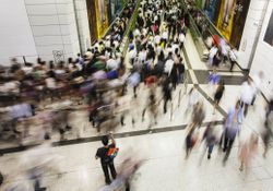 Blurred photo of people moving in busy transit area