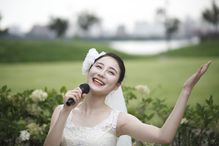 Happy bride singing with microphone