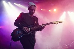 Guitarist performing on stage at music concert