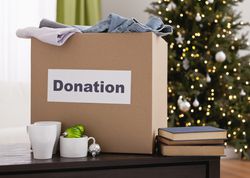 Donation box on table with christmas tree in background