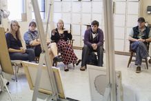 Artists critiquing work in studio