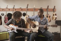 Father and son playing guitars together