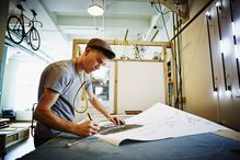 Neon artist drawing at work table in industrial loft