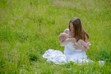 Young woman lulling her baby son