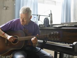 mature man playing guitar