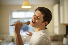 Man singing with wooden spoon