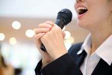 Close up of businesswoman with microphone speaking