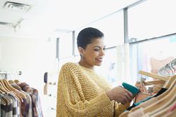 store owner adding pricetags to clothes