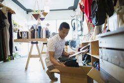 a man in a store working on his inventory