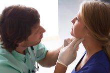 Doctor examining an patient's throat