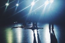 People Rehearsing On Illuminated Stage