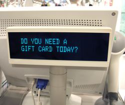 Cash register gift card offer in department store