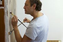 Artist using a mahl stick