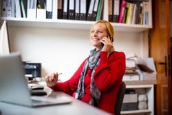 An SMB owner finishes up a call with her accountant.