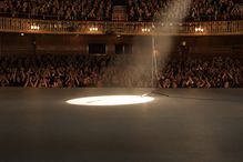 spotlight next to mic on an empty stage