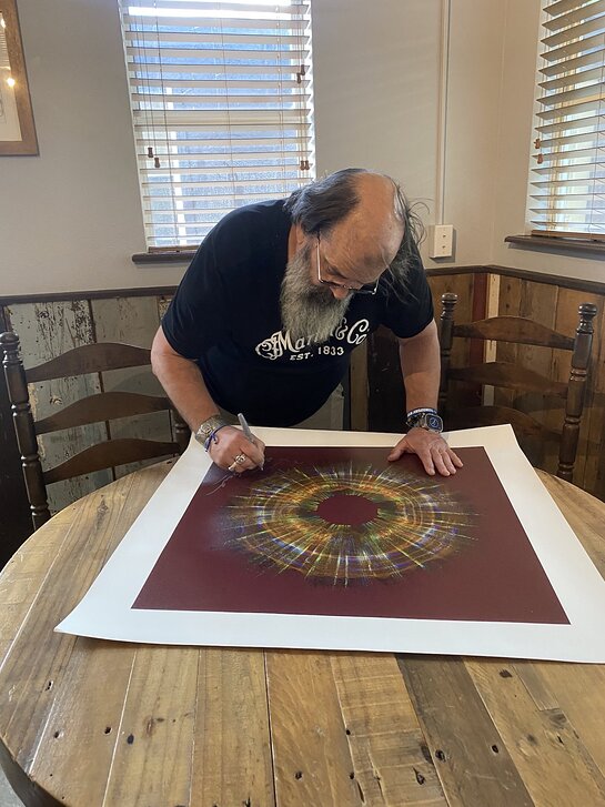 Steve Earle signs artworks made from the sound waves of Guitar Town