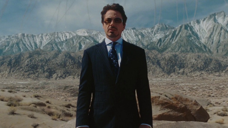 Tony Stark standing in front of mountains