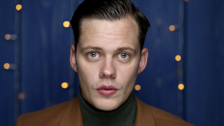 Bill Skarsgård turtleneck brown jacket