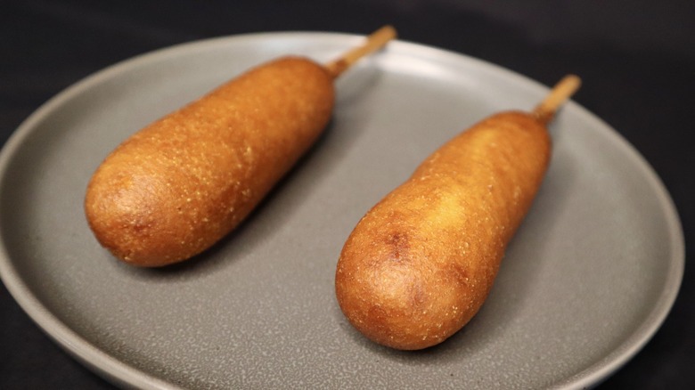 Corn dogs on gray plate