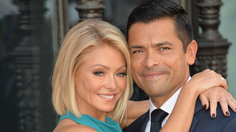 Kelly Ripa and Mark Consuelos hugging and smiling