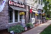 Flags fly outside the Waterfall Bar & Grille, Thursday, June 27, 2024, in Canton, Mass. Video evidence presented in the trial of Karen Read, showed the Waterfall as the last place where Read and her boyfriend John O'Keefe were seen together in public. A jury is deliberating the fate of Read, who is charged with second-degree murder in O'Keefe's death. (AP Photo/Charles Krupa)