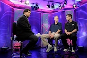 Greg Gumbel, left, watches as Connecticut head coach Jim Calhoun talks to Butler head coach Brad Stevens, right, prior to taping a television interview for the men's NCAA Final Four college basketball championship game Sunday, April 3, 2011, in Houston. (AP Photo/Eric Gay, File)