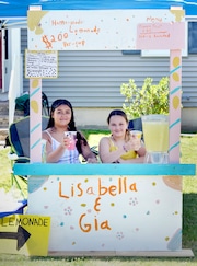 Gia Rolon (left) and Lisabella Beaulieu, both 10, operate a lemonade stand in front of 50 Burnside Terrace in Springfield.  (Don Treeger / The Republican)  7/3/2024