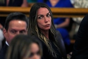 Karen Read stands as jurors depart the court for the weekend at the trial of Read at Norfolk Superior Court, Friday, June 28, 2024, in Dedham, Mass. Read, 44, is accused of running into her Boston police officer boyfriend with her SUV in the middle of a nor'easter and leaving him for dead after a night of heavy drinking. (AP Photo/Charles Krupa, Pool) 