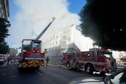 Fire crews battle a building fire on the 1200 block of South Hope Street Thursday, Dec. 26, 2024, in Los Angeles.