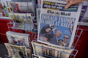 A woman buys a copy of the British Mail on Sunday newspaper at a newsagents in London, Sunday, July 14, 2024, showing the reaction to events at former President Trump's campaign rally in Butler, Pennsylvania. Donald Trump's campaign says he is "fine" after what law enforcement officials are treating as an assassination attempt during a rally in Butler, Pennsylvania. (AP Photo/Kirsty Wigglesworth)