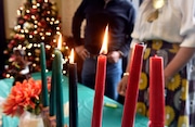 Kawanzaa candles burn during a celebration of the holiday at Holyoke City Hall.   (Don Treeger / The Republican)  12/28/2022