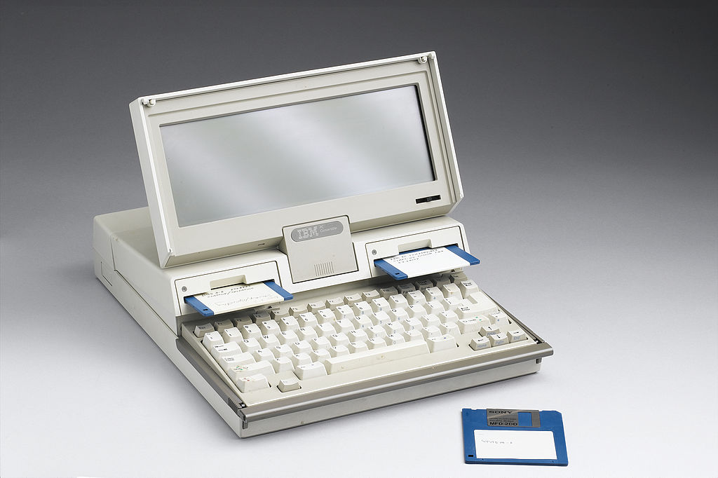 1980s model 5140 laptop with small screen and three blue floppy disks