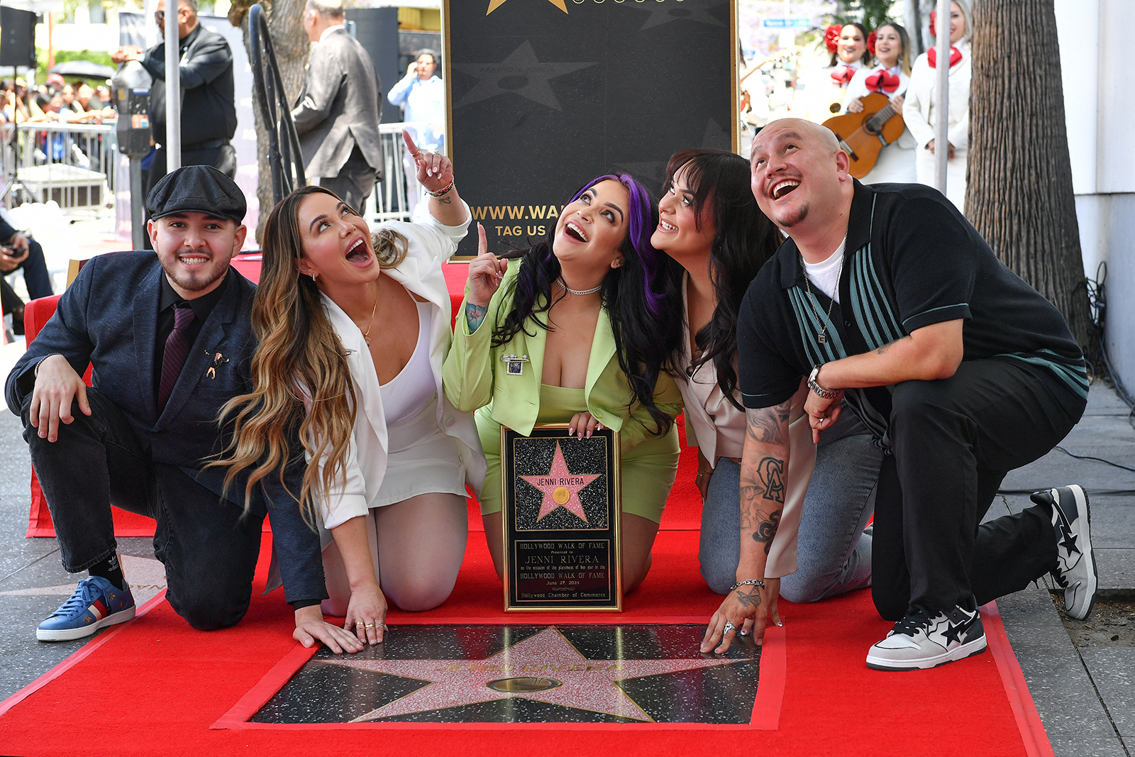 Jenni Rivera's children, from left, Johnny Lopez, Chiquis Rivera, Jacqie Rivera, Jenicka Lopez and Michael Rivera, pose on the star of their late mother during her posthumous Hollywood Walk of Fame ceremony in Los Angeles on June 27, 2024. (Valerie Macon/AFP via Getty Images/TNS)