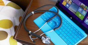 a laptop computer sitting on top of a wooden table