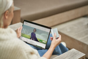 a person sitting at a table using a laptop