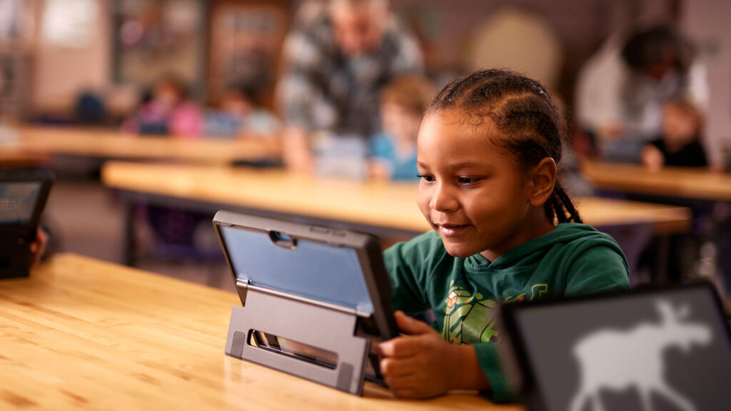 Student playing on tablet.