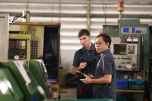 Technicians inspect CNC machines using computer controlled software programs.