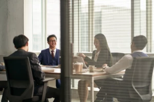 Corporate executives discussing business in a conference room.