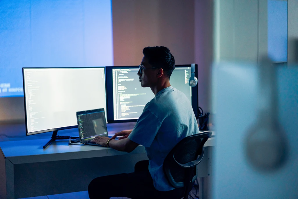 Computer developer working at night in office.