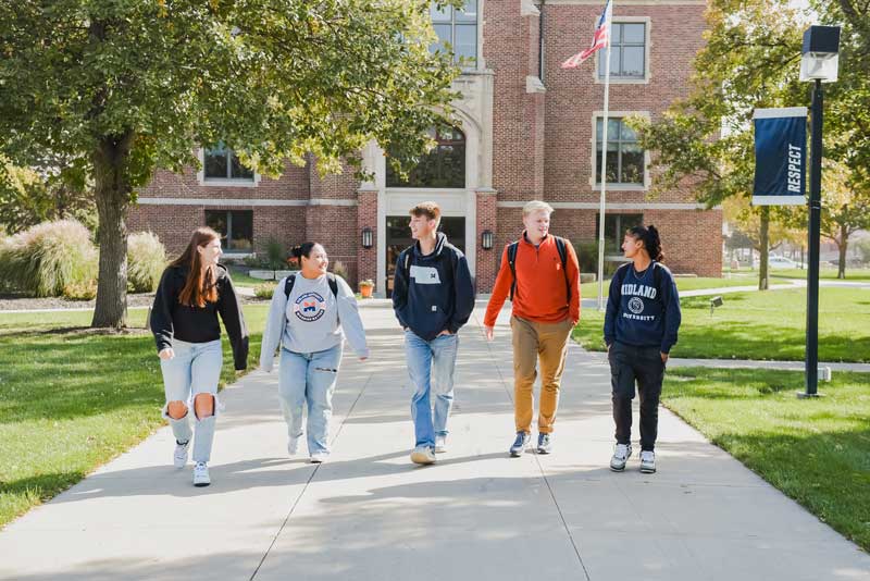 Students walking across campus in fall